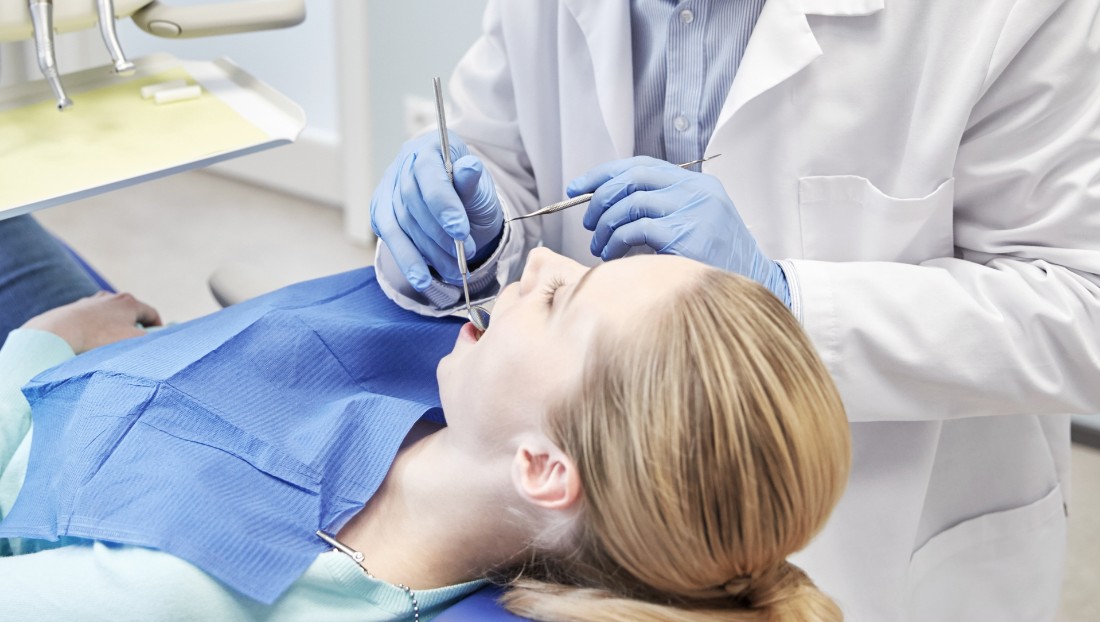 Patient in dental chair receiving gum disease treatment 